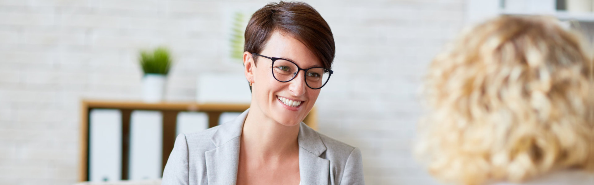 woman with glasses smiling